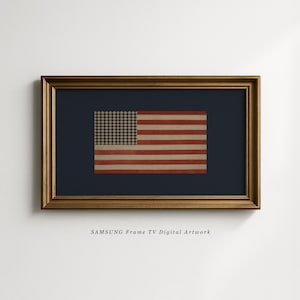 May include: A framed digital artwork featuring a vintage American flag design. The flag has a navy blue background, a gold frame, and a distressed look. The text "SAMSUNG Frame TV Digital Artwork" is at the bottom.