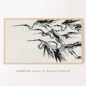 May include: A framed digital artwork featuring a flock of cranes in flight, rendered in a traditional Asian ink wash style. The birds are depicted in shades of gray and black with red accents on their heads, set against a cream-colored background. The frame is light-colored wood. Text reads "SAMSUNG Frame TV Digital Artwork."