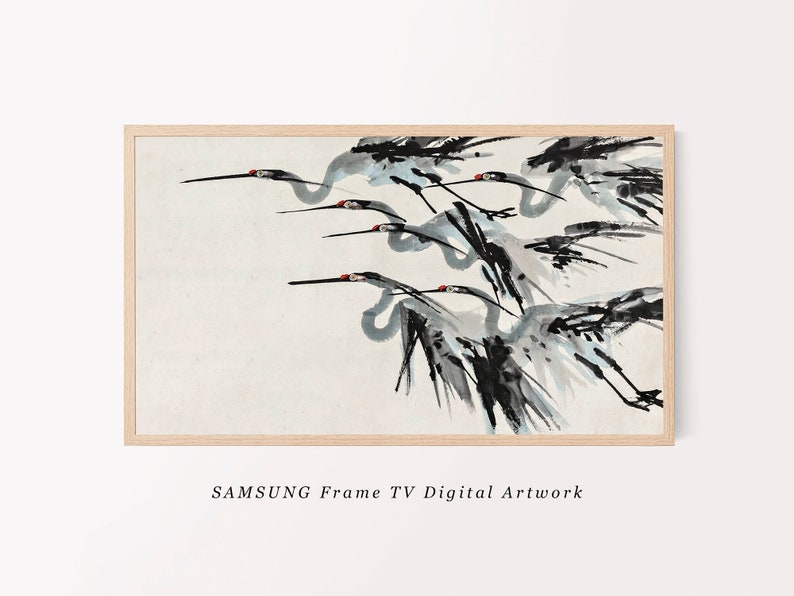 May include: A framed digital artwork featuring a flock of cranes in flight, rendered in a traditional Asian ink wash style. The birds are depicted in shades of gray and black with red accents on their heads, set against a cream-colored background. The frame is light-colored wood. Text reads "SAMSUNG Frame TV Digital Artwork."