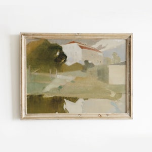 May include: A framed painting depicting a landscape scene with a house in the background. The painting is done in muted tones of green, brown, and white, with a hint of red on the roof of the house. The painting is framed in a simple, light wood frame.