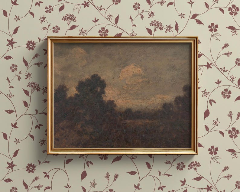 May include: A framed landscape painting depicting a misty, wooded scene with a golden sky. The painting is in a simple, gold frame.