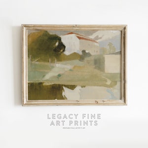May include: A framed painting of a landscape with a house in the distance. The painting is done in a muted color palette of greens, browns, and blues. The house has a red roof and white walls. The painting is framed in a light wood frame.