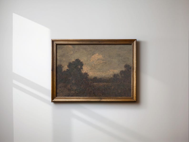 May include: A framed landscape painting depicting a forest scene with a cloudy sky. The painting is in a brown wooden frame.