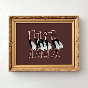 May include: A framed print of a group of seven black and white cranes walking in a line on a maroon background.