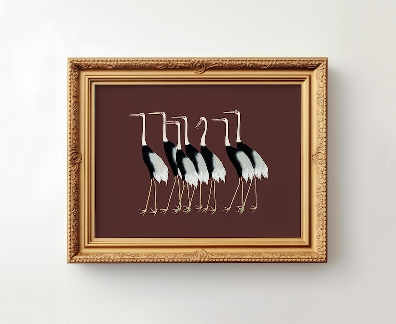 May include: A framed print of a group of seven black and white cranes walking in a line on a maroon background.