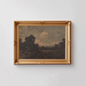 May include: A framed landscape painting depicting a dark, wooded scene with a cloudy sky. The painting is in a gold frame with ornate details.