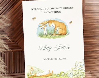 Puede incluir: Un letrero de bienvenida para baby shower sobre un caballete. El letrero presenta una ilustración de acuarela de una liebre marrón y una liebre blanca más pequeña. El texto dice "BIENVENIDA A LA BABY SHOWER EN HONOR A Amy Jones 14 DE DICIEMBRE DE 2025."