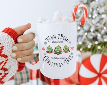 May include: White ceramic mug with a Christmas tree design. The mug says "Farm Fresh Baked with Holiday Cheer Christmas Tree".