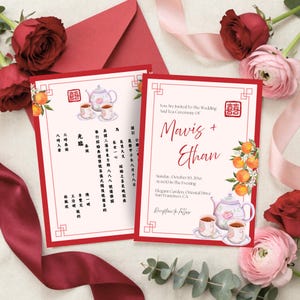 May include: Two rectangular wedding invitation cards with red borders and a double happiness symbol. The design features watercolor illustrations of oranges, a teapot, and two teacups. The text includes Mavis + Ethan, wedding details, and Chinese characters.