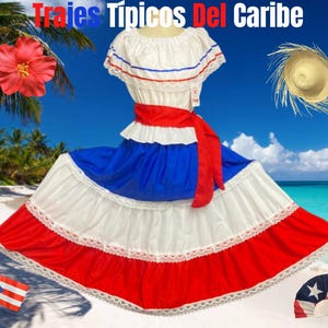 May include: A traditional Caribbean dress in red, white, and blue, with the text "Trajes Típicos Del Caribe." The dress features a ruffled skirt and a red sash. A straw hat, a red hibiscus flower, a flag, and a fan are also visible.
