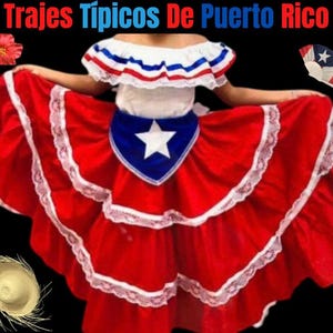 May include: A red, white, and blue dress with a ruffled top and a layered skirt. The skirt has white lace trim. The dress features a blue sash with a white star in the center. The text "Trajes Tipicos De Puerto Rico" is written at the top of the image.