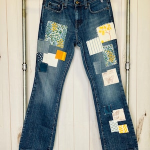 Upcycled Vintage Levi’s size 8 high waisted Patched Denim Reworked Women’s Jeans
