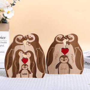 May include: Wooden penguin family figurine set with a red heart. The penguins are carved with the names "Mommy", "Daddy", "Mia", "Mason", "James", "Sophia", "Lucas", and "Levi".