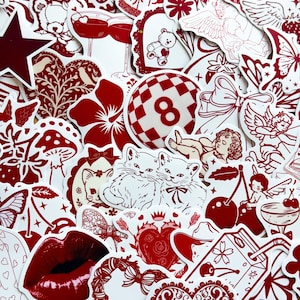 May include: A selection of red and white stickers with diverse designs. The stickers showcase images of cats, cherries, hearts, angels, and other decorative elements. The stickers are closely arranged, forming a visually rich and detailed pattern.