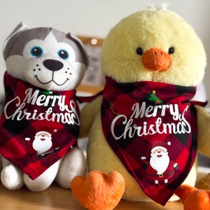 May include: Two plush toys wearing red and black plaid bandanas with the text "Merry Christmas" in white. The toys are a gray and white husky dog and a yellow chick.