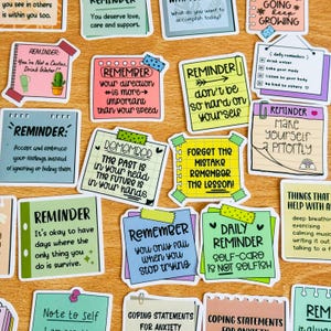 May include: A collection of colourful reminder stickers with positive messages and affirmations. The stickers feature a variety of designs, including hearts, arrows, and stars. Some of the messages include "Remember your direction is more important than your speed", "Don't be so hard on yourself", and "Make yourself a priority".