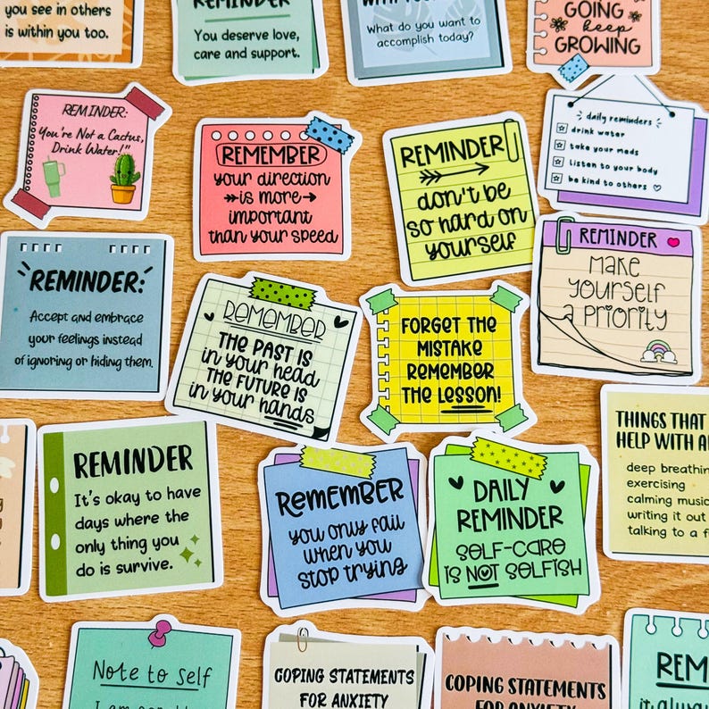 May include: A collection of colourful reminder stickers with positive messages and affirmations. The stickers feature a variety of designs, including hearts, arrows, and stars. Some of the messages include "Remember your direction is more important than your speed", "Don't be so hard on yourself", and "Make yourself a priority".