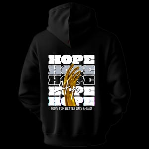 May include: Black hoodie with the word "HOPE" stacked vertically in white, gray, and blue. A golden hand reaches upward in the center. The phrase "HOPE FOR BETTER DAYS AHEAD" is printed at the bottom. The hoodie has a black hood.
