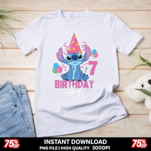May include: White t-shirt featuring a blue cartoon character wearing a party hat, with the number 7 and the words "BIRTHDAY Girl" in pink. The design includes balloons and confetti. The shirt is displayed on a light wooden surface.