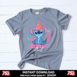 May include: A gray t-shirt featuring a cartoon character wearing a party hat and the number 7. The text "BIRTHDAY Girl" is below the character. Colorful balloons are also present. The shirt has a casual, relaxed fit.