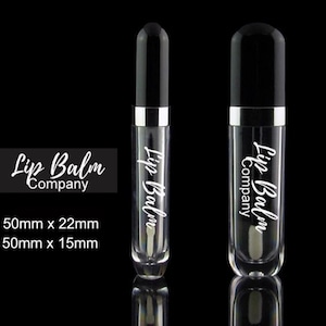 May include: Two clear lip balm tubes with black caps and silver bands. The tubes are labeled "Lip Balm Company" in white lettering. The tubes are 50mm x 22mm and 50mm x 15mm.