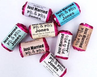 May include: Pink and white wrapped candy favours with the text "Just Married Mr & Mrs Jones" and the date "23.09.17". The favours also include the message "Would like to thank you for sharing their special day".