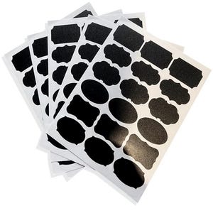 May include: A stack of white sheets with various black label shapes, including rectangles, ovals, and decorative frames. The labels have a textured surface, suitable for writing or printing. Ideal for organizing and labeling items.