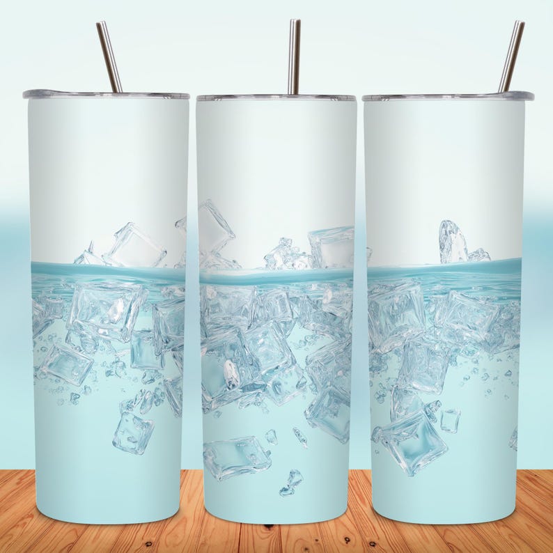 May include: Three stainless steel tumblers with a light blue design of ice cubes in water. Each tumbler has a silver lid and a silver straw. The tumblers are displayed on a wooden surface.