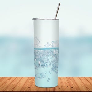 May include: A tall, cylindrical tumbler with a silver straw and lid. The tumbler is filled with ice cubes and water, creating a refreshing visual. The background is a soft blue gradient.
