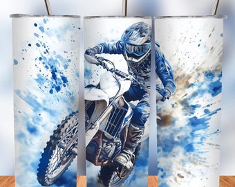 May include: A white and blue watercolor design on a stainless steel tumbler features a motocross rider in a blue and white racing suit, helmet, and goggles, riding a white dirt bike. The rider is in mid-air, with blue and white watercolor splashes behind them.