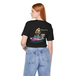 May include: A black t-shirt with a cartoon duck wearing glasses and using a computer. The text on the shirt reads "Healthcare Hero (Behind the Desk Edition)".