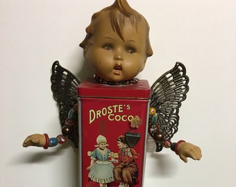 Assemblage  Doll, Hummel head and hands, Wings, Dutch Cocoa Tin