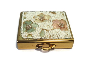 Compact in Gold tone metal with Embroidered Flowers and Beaded lid. Made in U.S.A