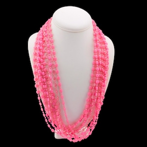 May include: A white ceramic mug with a black handle and the text "But First, Coffee" in a black, handwritten-style font. The mug is on a white surface.