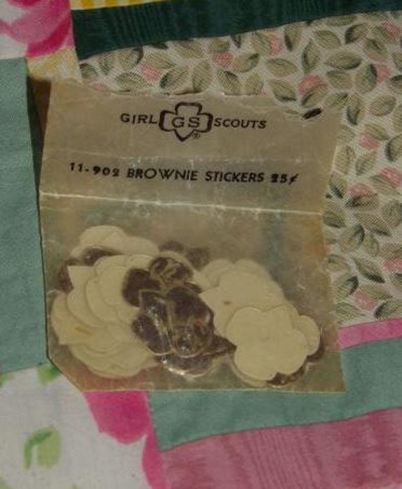 May include: A package of Girl Scout Brownie stickers with the Girl Scout logo and the text "11-902 Brownie Stickers 25&cent;".