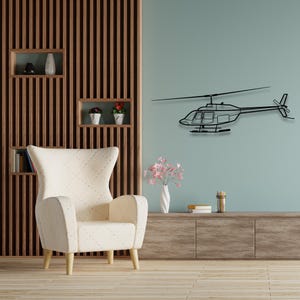 May include: A black metal helicopter wall decor with a white armchair and a wooden shelf with potted plants in the background.