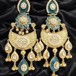 Gold plated kundan pearl chandbali earrings close up, intricate Indian wedding jewelry design