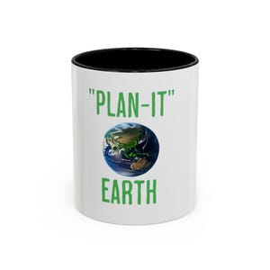 May include: White ceramic mug with a black rim. The mug has a green graphic of the Earth with the text "PLAN-IT" above and "EARTH" below.