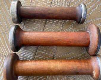 Three very old wooden and metal large spools for crafting or vintage decor.