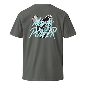 May include: A gray t-shirt featuring a black and white graphic of a turbocharger with the words "Mopar Power" in a stylized, light blue font. The shirt has short sleeves and a crew neck.