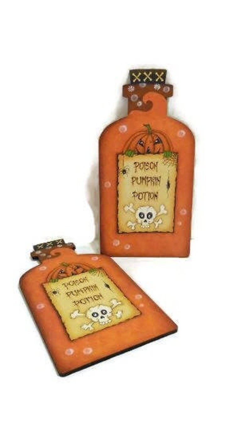 May include: Two orange wooden pumpkin potion bottles with a skull and crossbones and the text "Poison Pumpkin Potion" on a white background.