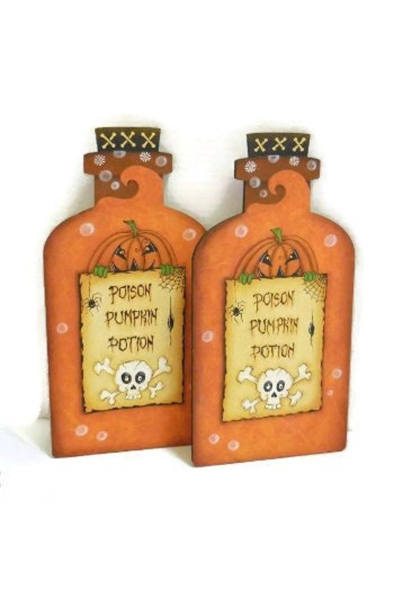 May include: Two orange and brown wooden pumpkin potion bottles with a skull and crossbones and the text "Poison Pumpkin Potion".