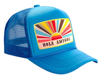 May include: A blue trucker hat with a colourful sunrise and "Hola Amigos" text on the front.