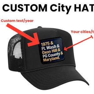 May include: Black trucker hat with a mesh back and a curved peak. The hat has a square patch with the text "1975 & Ft. Wash & Oxon Hill & PG County & Maryland." The words "CUSTOM City HAT" are at the top.