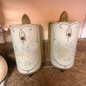 May include: A set of three ceramic mugs with a speckled, matte finish. The mugs are in shades of cream, light brown, and dark brown. Each mug has a simple, minimalist design and a rounded handle.