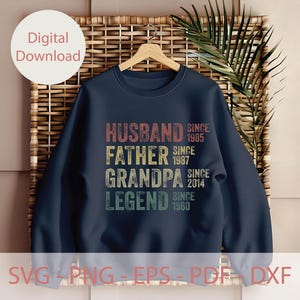 May include: Navy blue sweatshirt with the words "HUSBAND, FATHER, GRANDPA, LEGEND" in a retro font. The sweatshirt also includes the years "SINCE 1985, 1987, 2014, 1960". The words "Digital Download" are in a white circle.