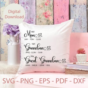 May include: White throw pillow with black text that reads "First Mom Est. 1970 Liam - Noah - Oliver Then Grandma Est. 2003 James - Elijah - Olivia Now Great Grandma Est. 2024 Emma - Amelia - Sophia - Rose"