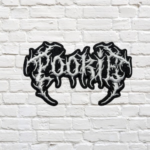 May include: Black and white embroidered patch with the word "TOOLKIT" in a stylized, gothic font.