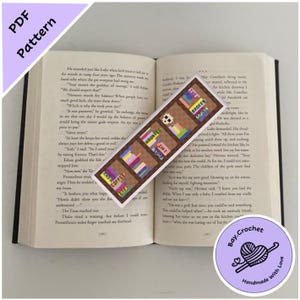 May include: A colorful crocheted bookmark with a bookshelf design. The bookmark features four shelves with different colored books, including "Haunted", "Gift", "Coffee", and "The Broken Spine".