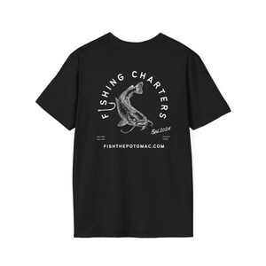 May include: Black t-shirt with a white graphic of a fish inside a circular design that reads "Fishing Charters" and "Est. 2024". The text "fishthepotomac.com" is printed below the design. A casual tee for fishing enthusiasts.